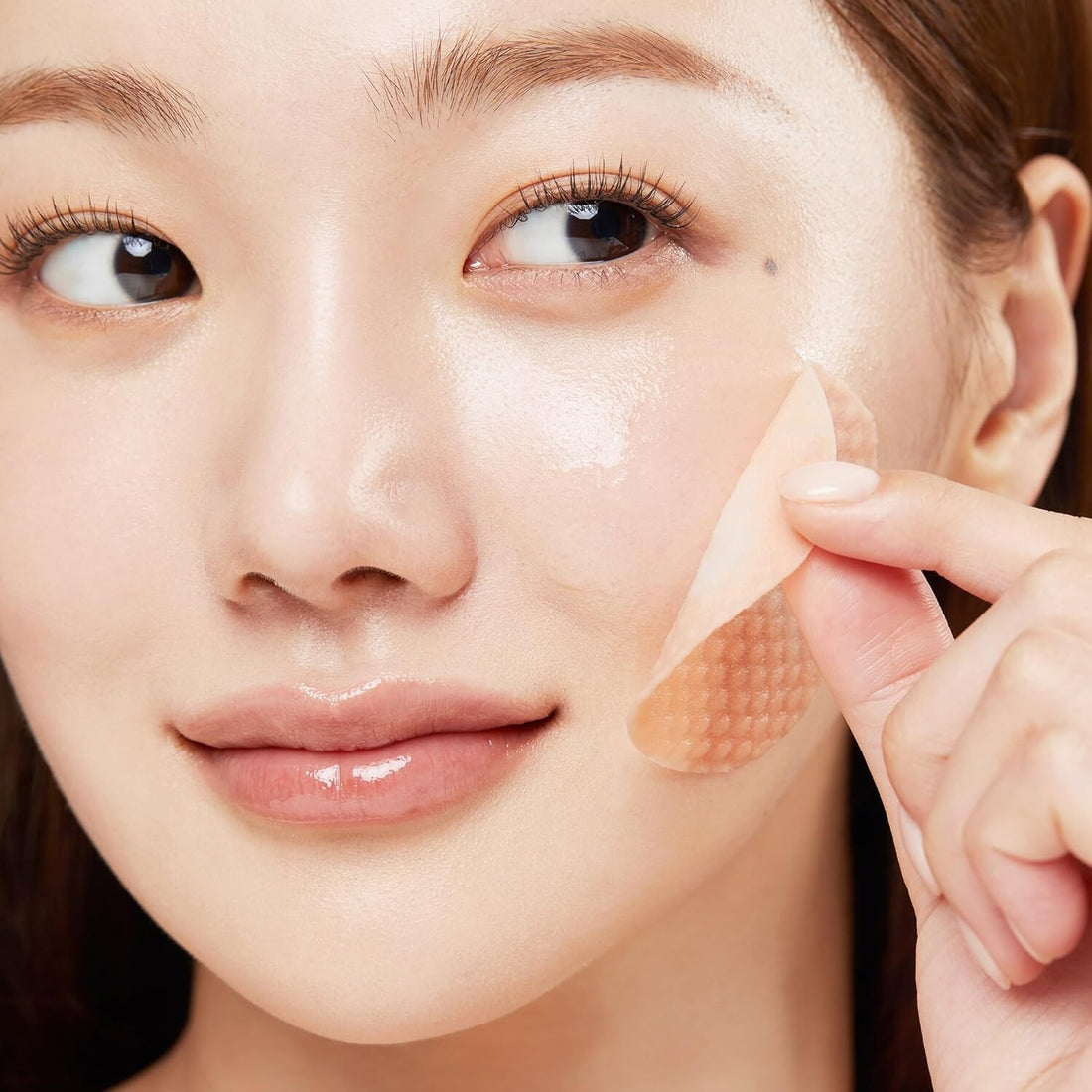 Woman using Medicube Red Succinic Acid Peeling Pad for glowing skin; red succinic acid peeling pads.