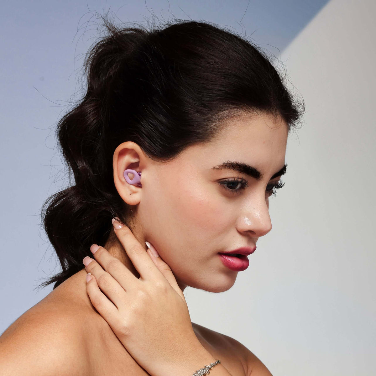 ZENZ Unwind Pro Earplugs in Nebula Purple shown in use, ideal noise reducing earplugs for sleep for ultimate relaxation.