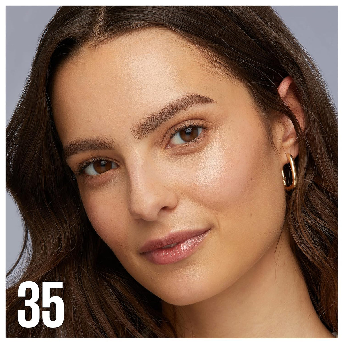 Model showcasing Maybelline Green Edition Superdrop Tinted Oil Foundation with jojoba and marula oil.