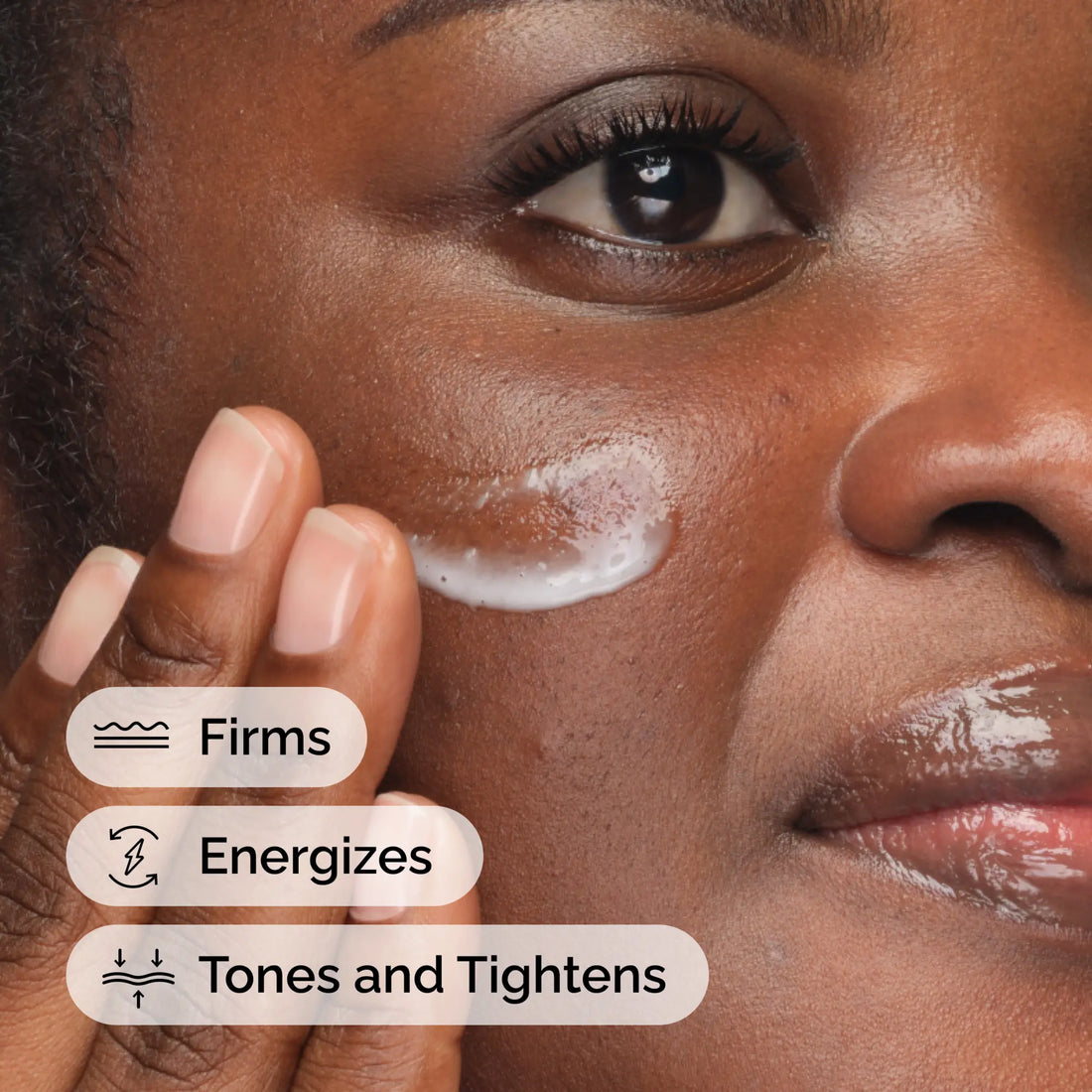 Close-up of a person applying an energizing caffeine face serum, showcasing its refreshing and firming properties.